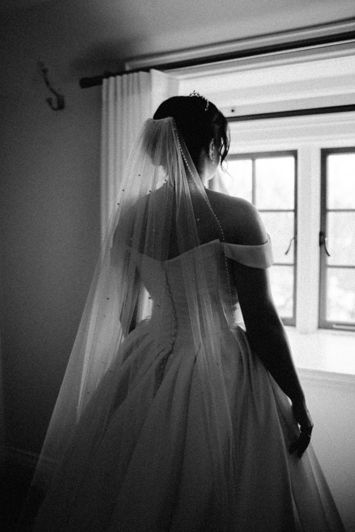 Bride by the window in black and white